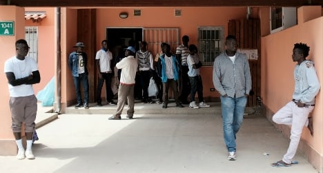 Migrants stand at the Mineo centre in Sicily. Photo: Alberto Pizzoli