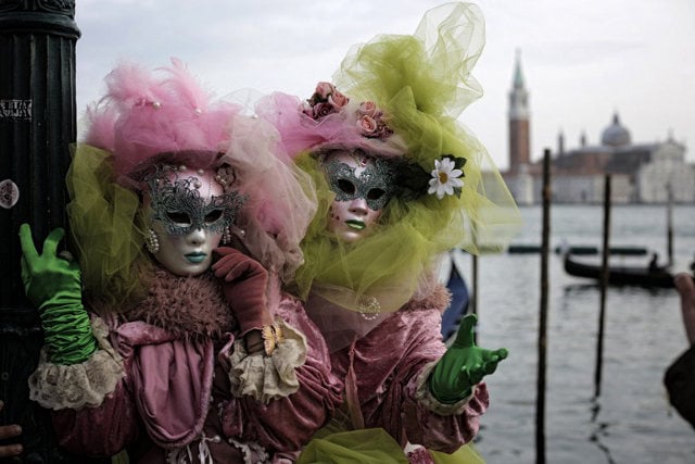 Masked revellers pose for a photo during Venice’s carnival celebrations.