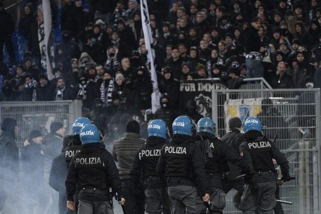 Italian police arrest rowdy German football fans after clashes in Rome