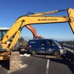 Armed gang use diggers to 'rip open' security van