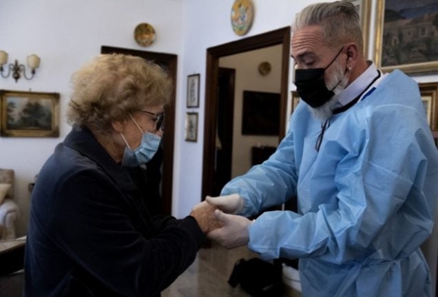 An elderly lady in Italy receives the Covid vaccine.