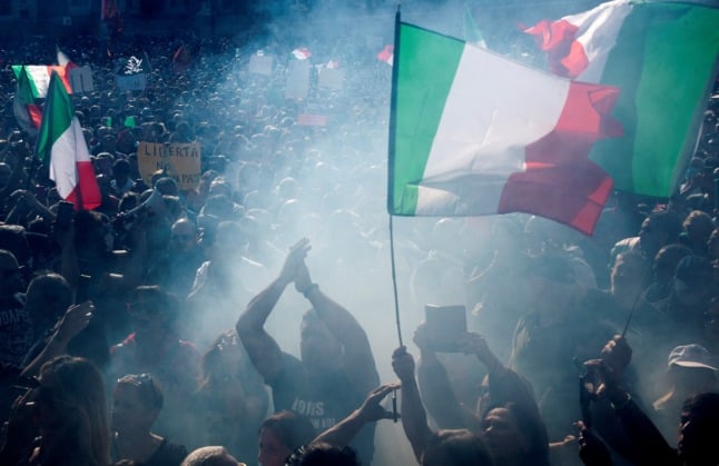 Thousands of people gather in the Piazza Del Popolo to protest an expansion of Italy's 'green pass' system.
