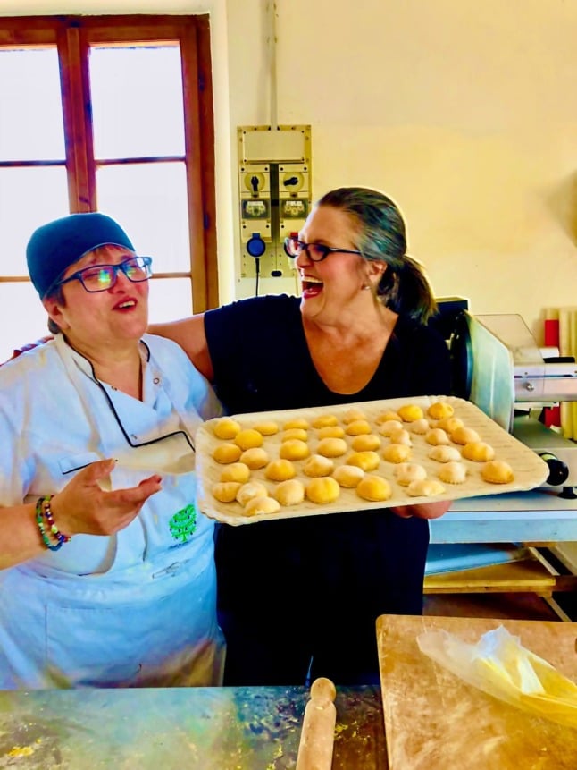 Linda Meyers in the kitchen with one of their local cooks