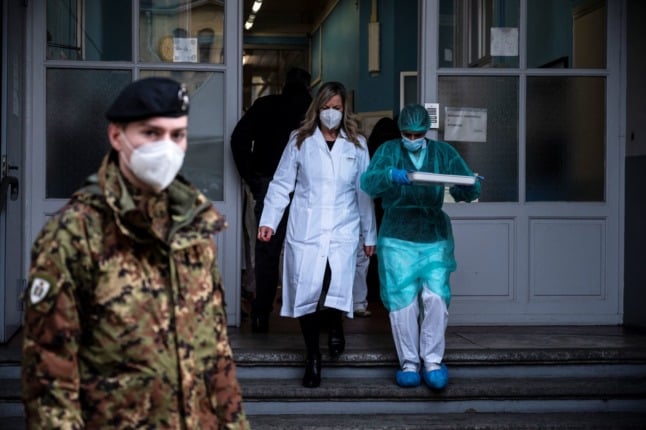 A nurse carries Covid-19 vaccination shots at the Amedeo di Savoia Hospital, in Turin, Northwestern Italy, on December 27, 2020. 