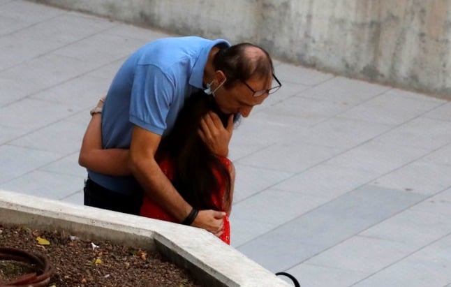 Shmuel Peleg, the grandfather of Eitan Biran, hugs a relative outside the Justice Court in the Israeli coastal city of Tel Aviv on October 8, 2021. 