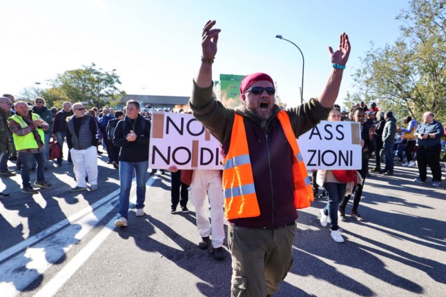 Dockers and port workers demonstrate outside the Port of Trieste’s Gate 4 on October 15, 2021 to protest new coronavirus restrictions for workers. 