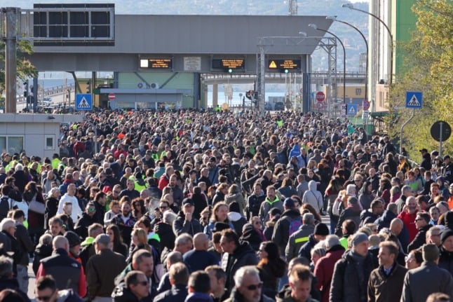 Dockers and port workers gather for a protest in the port of Trieste, Friuli Venezia Giulia, on October 15, 2021 as new coronavirus restrictions for workers come into effect. 