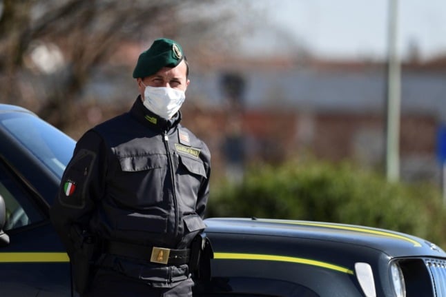 A member of Italy’s Guardia di Finanza Financial Police Force patrols a check-point at an entrance to the small town of Zorlesco on February 26, 2020.