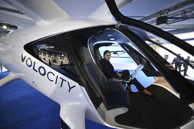 A woman sits aboard the VoloCity drone air taxi at the Piazza San Silvestro in Rome, on November 4, 2021. 