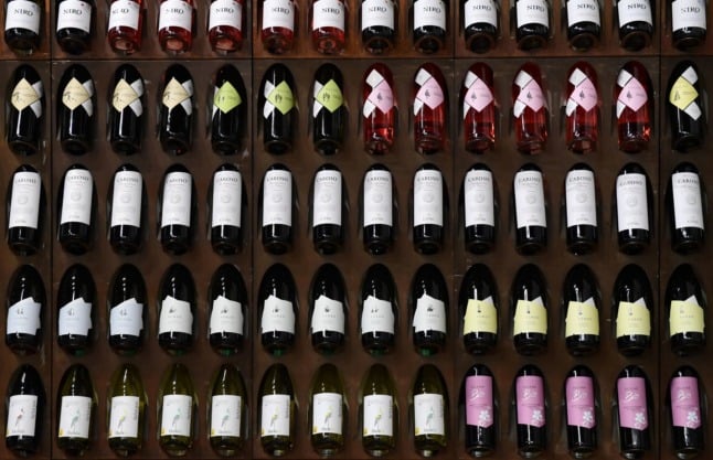 Bottles of Italian red wines are displayed on the stand of Abruzzo's wine growing cooperative Codice Citra on May 8, 2019 at the TUTTOFOOD fair in Milan. 